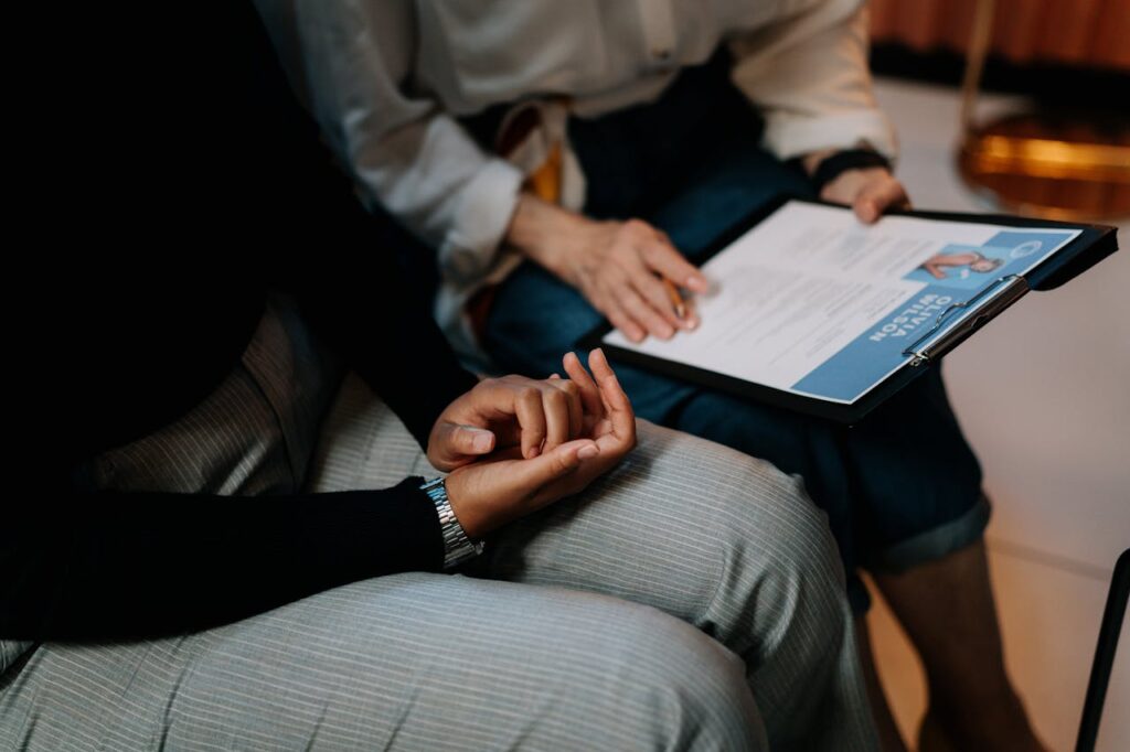 pexels-photo-5989933 Two professionals reviewing a resume in an office setting, focused on teamwork.